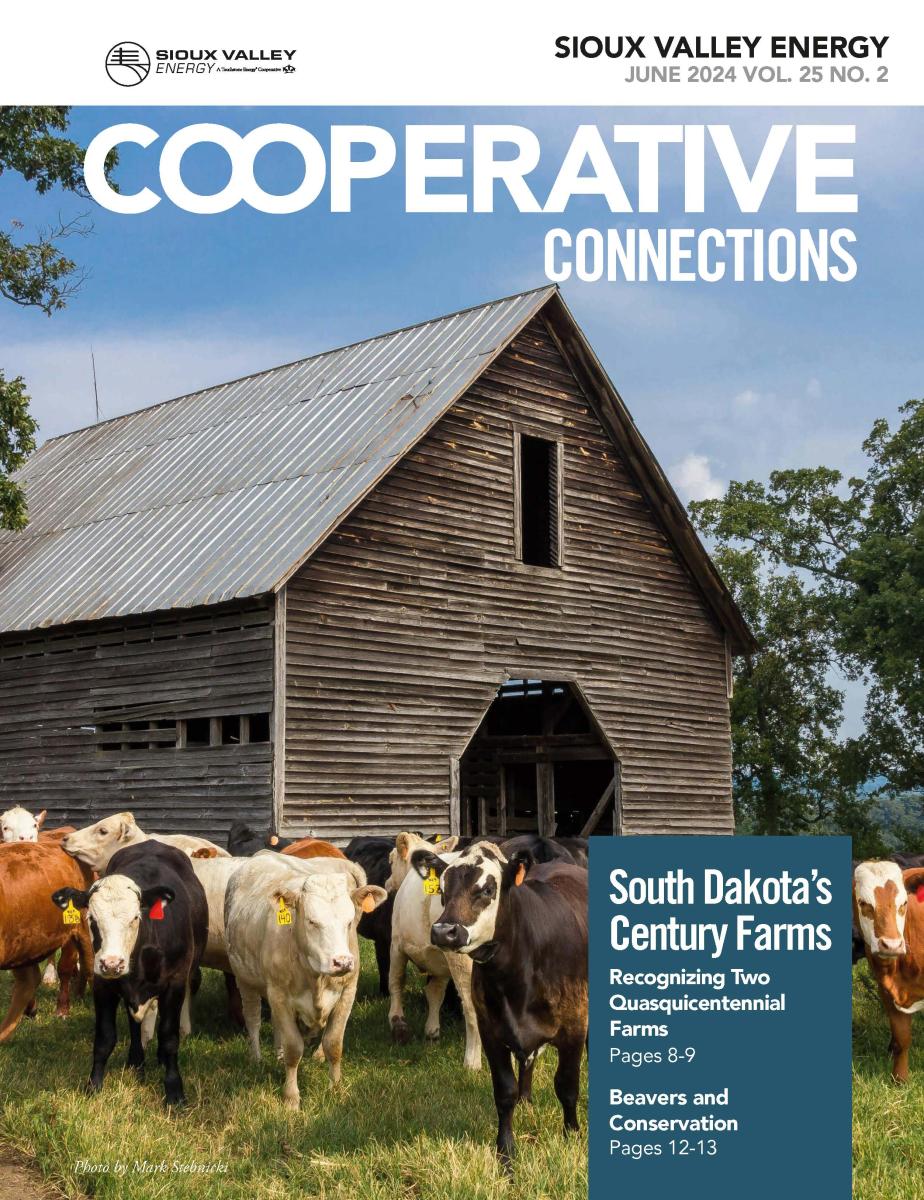 June 2024 magazine cover of farm building with cattle in foreground