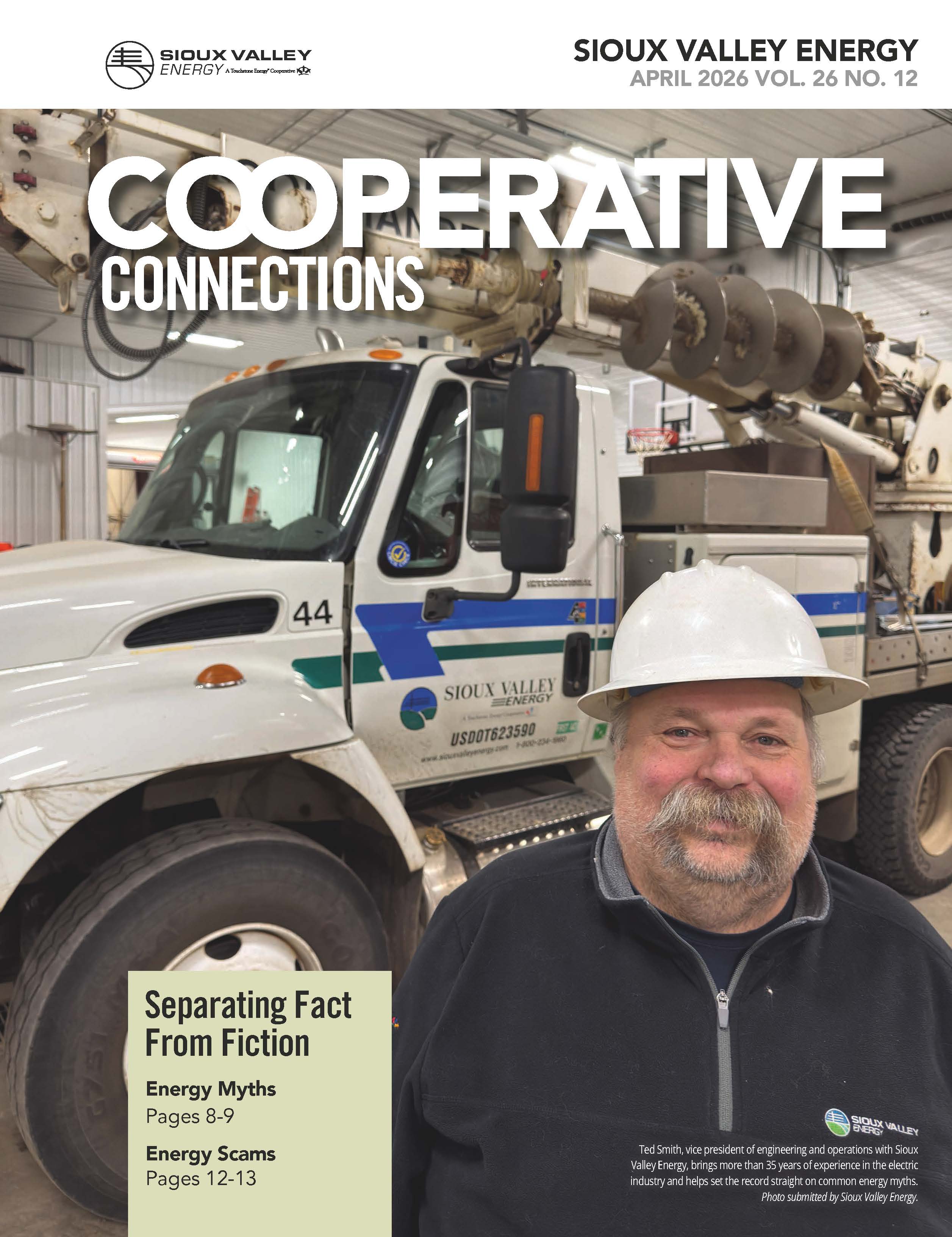 Cover of April 2026 issue of magazine featuring a man in a hardhat standing in in front of a bucket truck in a garage warehouse.