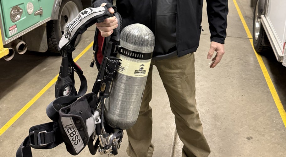 Ryan LaBrune holds a firefighter’s SCBA equipment that can now be refilled in Holland.