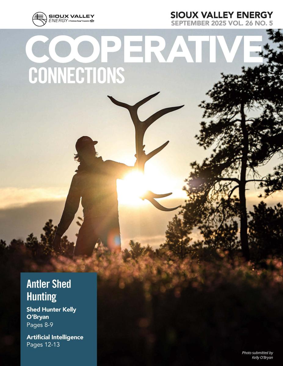 Magazine cover of a picture of a silhouette of man holding a large antler shed