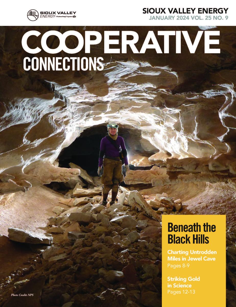 Cover of January 2024 Issue of magazine featuring person standing inside a cave