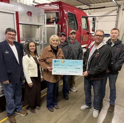 Sioux Valley Energy Director Gregg Johnson, SVE Vice President of Public Relations Carrie Vugteveen and Operation Round Up® Board member Julie Stevens present a check to members of the Holland Community Fire Department: Jason Borman, Ryan LaBrune, Merle Zeinstra, and Holdan Surat.