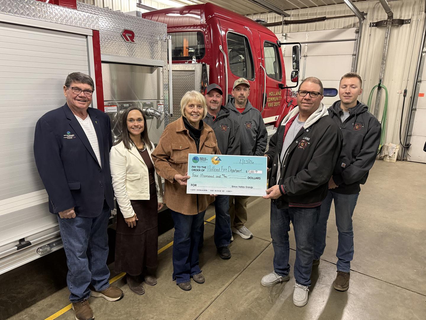 Sioux Valley Energy Director Gregg Johnson, SVE Vice President of Public Relations Carrie Vugteveen and Operation Round Up® Board member Julie Stevens present a check to members of the Holland Community Fire Department: Jason Borman, Ryan LaBrune, Merle Zeinstra, and Holdan Surat.